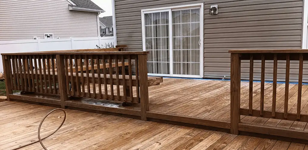 Deck sealing service protecting a backyard wood deck and railings in Peoria, IL