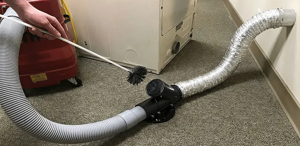 Dryer vent cleaning service removing lint from a dryer duct connection in Peoria, IL