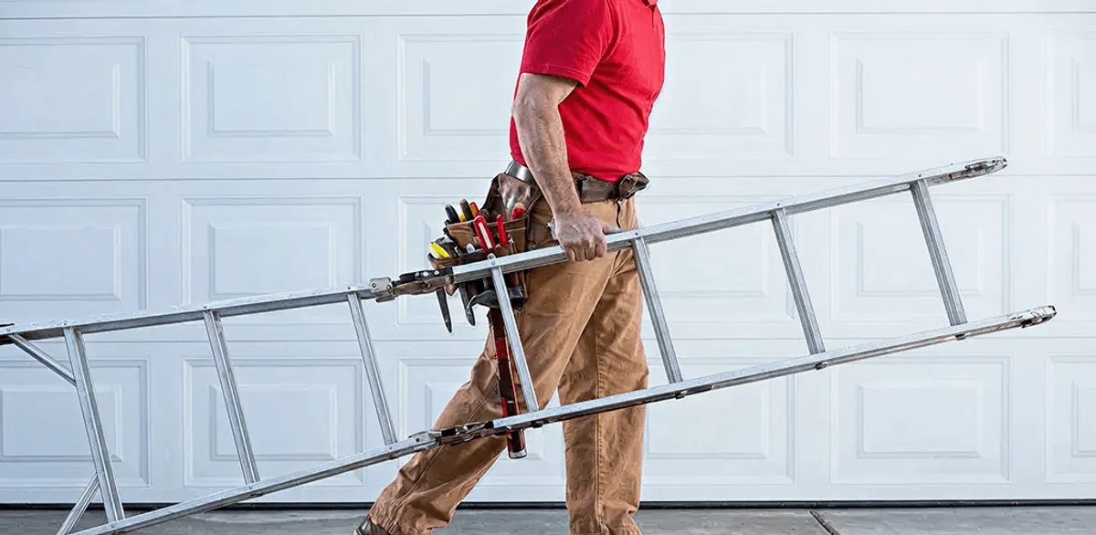 Garage door repair technician arriving with tools and ladder in Peoria, IL
