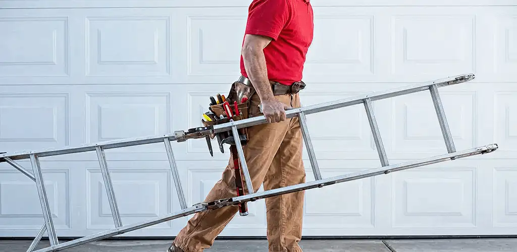 Garage door repair technician arriving with tools and ladder in Peoria, IL