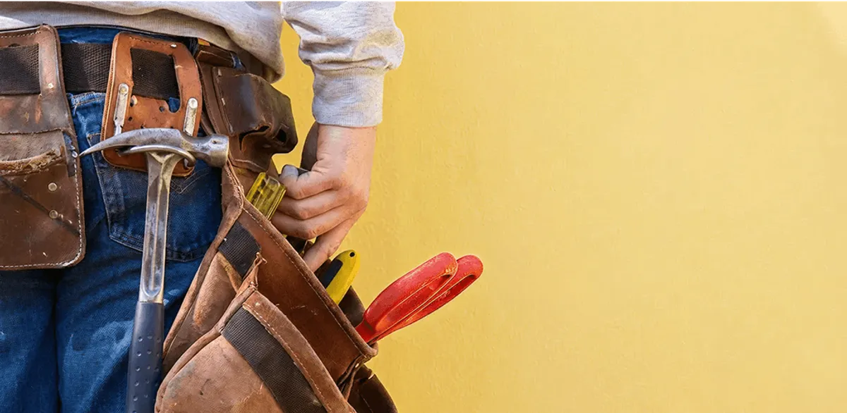 Handyman with tool belt ready for home repairs and maintenance in Peoria, IL