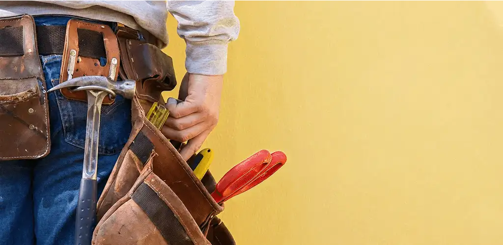 Handyman with tool belt ready for home repairs and maintenance in Peoria, IL
