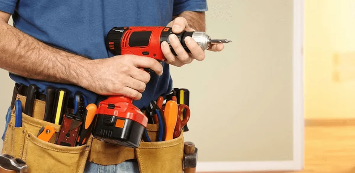 Handyman holding a power drill for home repairs and installations in Peoria, IL