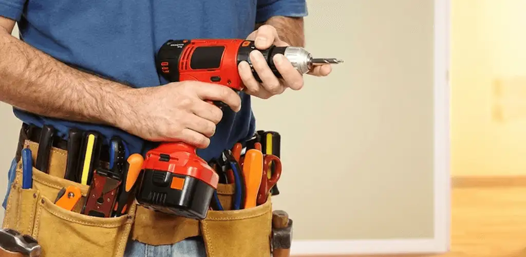 Handyman holding a power drill for home repairs and installations in Peoria, IL