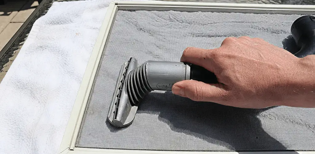 Window screen repair cleaning and fixing a damaged screen mesh in Peoria, IL