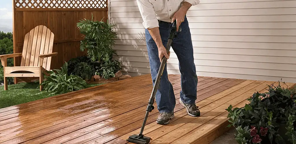 Deck staining service applying stain to a backyard wood deck in Peoria, IL